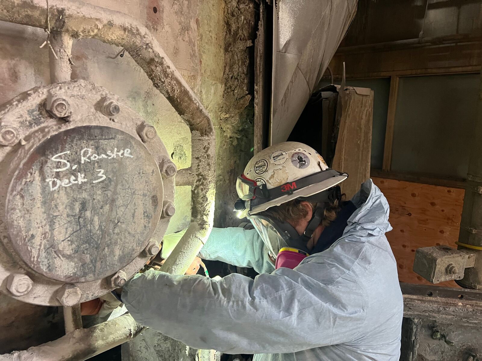 AIT inspector examining a bolted flange cover on Deck 3 of a sulfur roaster